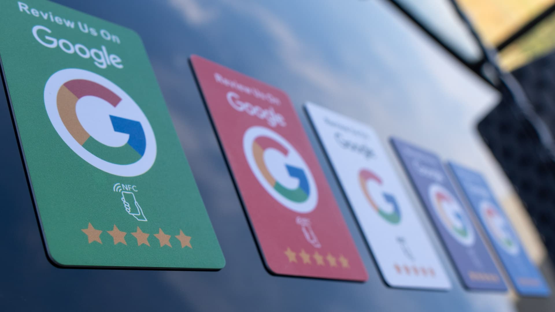 NFC review card held by business owner